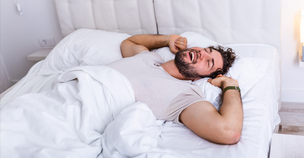 Man waking up after a good nights sleep